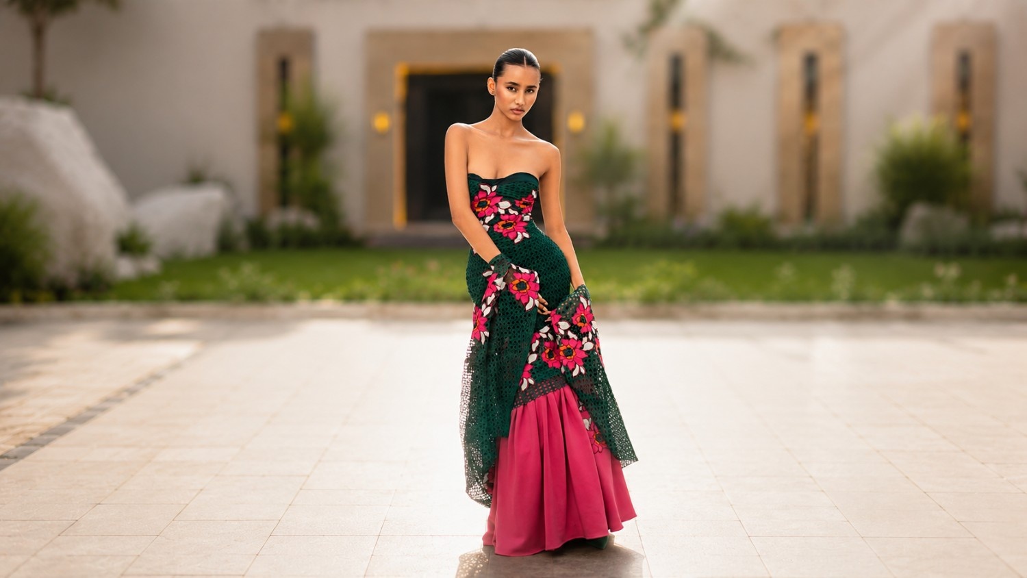 Model wearing the Emerald Reverie look in a courtyard setting